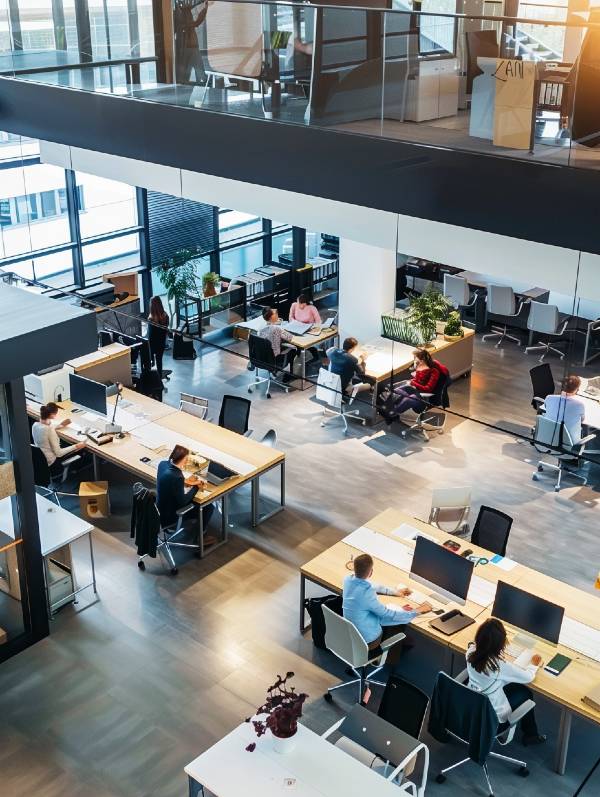 Modern office space with employees working at desks.